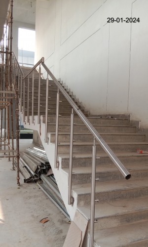 Academic Block- (Internal)-. Terrace Tile work in progress. Staircase railing installation work in progress.